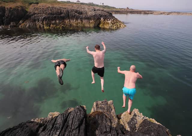 Tristan Brennan, Gary Niblock and Jamie Craig take a dive off the rocks at Orlock, Co Down yesterday as Northern Ireland sweltered again in record-breaking temperatures
Pic: Jonathan Porter/PressEye