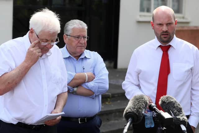 Solicitor John Fox (right) with Stanley McCombe (centre), who lost his wife Ann and Michael Gallagher (left) who lost his son Aiden in the Omagh bombing speaking to the media outside the Omagh support centre.