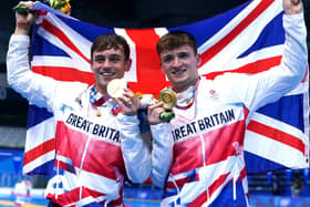Great Britain's Tom Daley (left) and Matty Lee celebrate winning gold in the Men's Synchronised 10m Platform Final at the Tokyo Aquatics Centre on the third day of the Tokyo 2020 Olympic Games