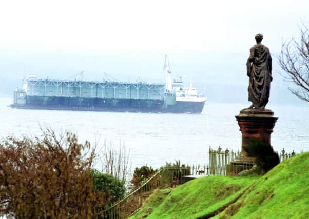 The statue of Highland Mary looks out over the Holy Loch at Dunoon as a large ship passes in February 1992.