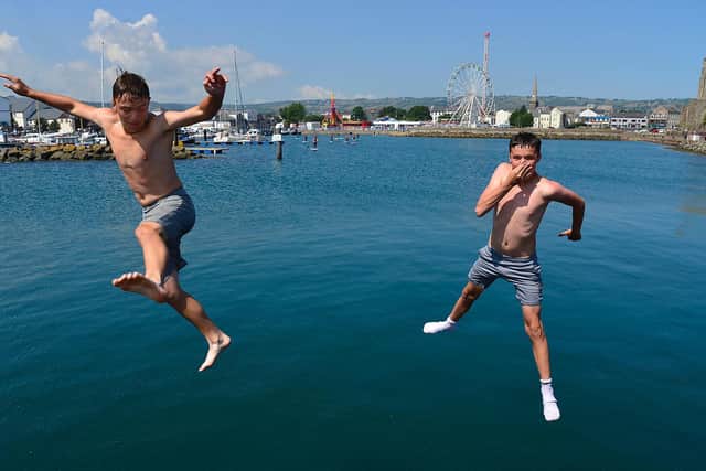 Summer weather in NI last month - Joel Mooney and Tyler Kelly pictured enjoying the water in Carrickfergus. (Photo: Arthur Allison/Pacemaker Press)