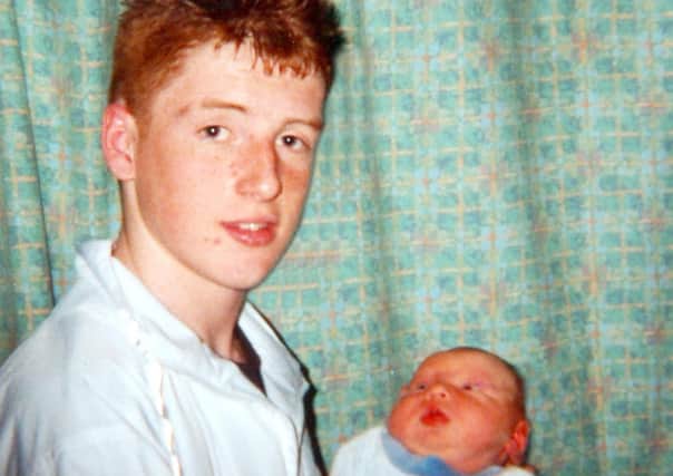 Michael McIlveen, 15, who was beaten to death in 2006, holding his godson Paul