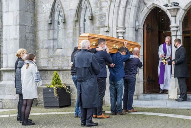 Anne O'Sullivan, in the middle of the three people on the left of the photograph, watches as the coffin of her son Mark  is carried into the Church of the Immaculate Conception, Kanturk, Co Cork, for his funeral. Mark was murdered by his brother Diarmuid his father Tadgh