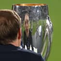 Chelsea manager Thomas Tuchel looks at the trophy after the UEFA Super Cup final at Windsor Park in Belfast. Pic by PA.