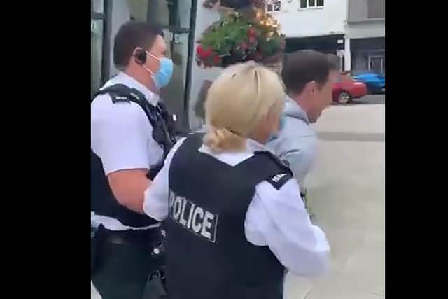 The PSNI arrest preacher Ryan Williamson in Larne on Tuesday.