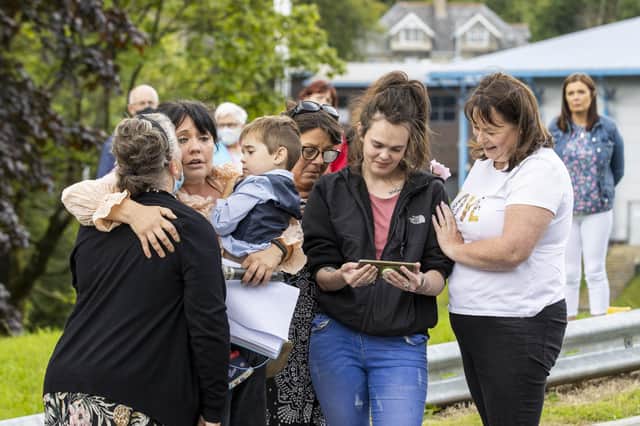 People comforting each other during a vigil in Dungannon, Co Tyrone, for two-year-old for Ali Jayden Doyle who died from a serious head injury in hospital on August 6.