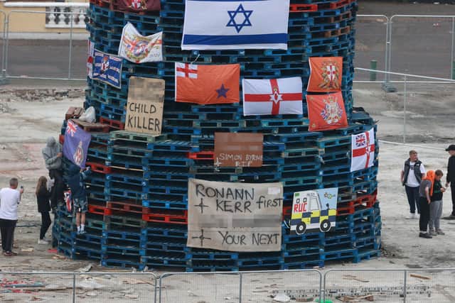 Flags and banners are hung on a large bonfire built to mark the Catholic Feast of the Assumption in the Bogside area of Londonderry.