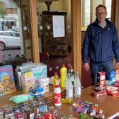 Rev Jimmy Warburton at the 'manna table' of donated items in Holywood