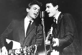 FILE - In this July 31, 1964 file photo The Everly Brothers, Phil, left, and Don, perform on stage