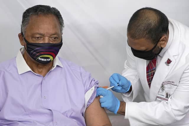Rev. Jesse Jackson receives the Pfizer's BioNTech Covid-19 vaccine at the Roseland Community Hospital in Chicago in January this year. The Rev. Jesse Jackson and his wife, Jacqueline, have been hospitalized after testing positive for Covid-19  (AP Photo/Charles Rex Arbogast, File)