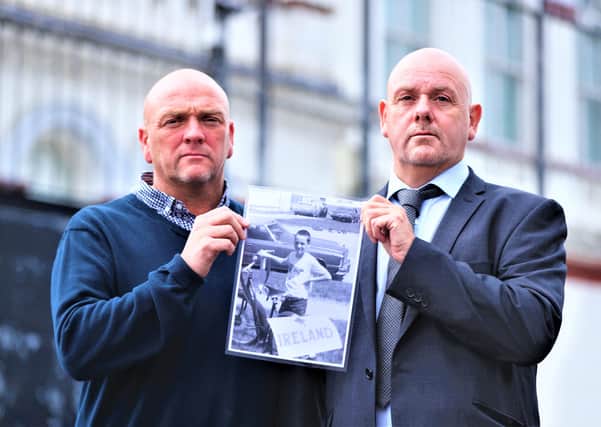 Joe (left) and Kieran Geddis hold a picture of their brother Stephen, who died aged 10, in 1975, after he was struck by a plastic bullet, outside Banbridge Court House where a fresh inquest into his death is being held. Picture date: Monday August 23, 2021.
