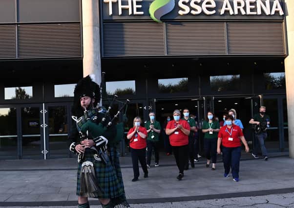 A piper played at the SSE Arena in Belfast on Sunday to mark the closure of the venue as a mass vaccination centre