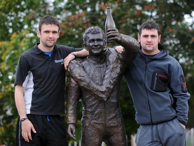 William Dunlop (left) with his brother Michael pictured alongside the statue of their father Robert at the Dunlop Memorial gardens in Ballymoney.
