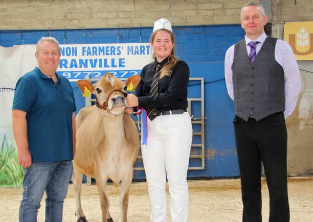 Aisla Fleming, Seaforde, was the supreme champion in the Jersey showmanship section at the 18th Multi-Breed Dairy Calf Show, held at Dungannon. Adding their congratulations are Mark Logan, Ulster Jersey Cattle Club; and judge David Gray. Picture: Julie Hazelton