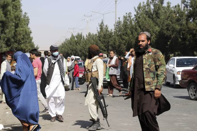 Taliban fighters stand guard outside the airport after Thursday's deadly attacks, in Kabul, Afghanistan, Friday, Aug. 27, 2021. Two suicide bombers and gunmen attacked crowds of Afghans flocking to Kabul's airport Thursday, transforming a scene of desperation into one of horror in the waning days of an airlift for those fleeing the Taliban takeover. (AP Photo/Wali Sabawoon)