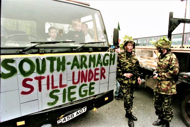Soldiers in Crossmaglen in 1994, surrounded by Sinn Fein protestors, who converged on the police/army barracks to object to its presence in the village