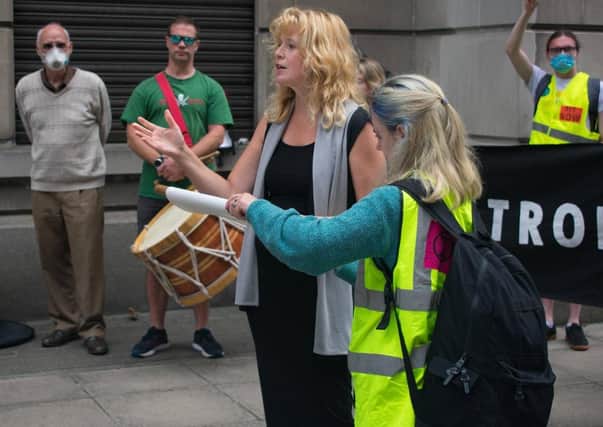 Diane Little addresses an Exctinction Rebellion protest at the Department of the Economy in Belfast