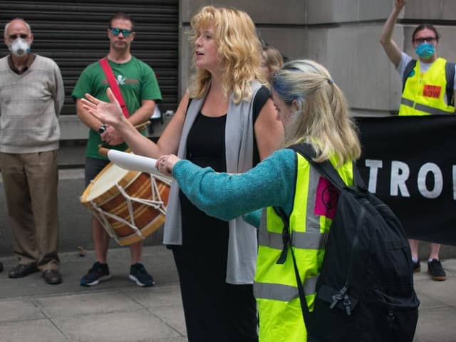 Diane Little addresses an Exctinction Rebellion protest at the Department of the Economy in Belfast