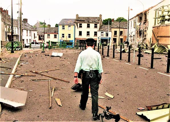 June 24, 1998: A lone RUC man surveys the rubble after a huge INLA car bomb wrecked the village of  Newtownhamilton in south Armagh; the bomb went off as police were clearing the area