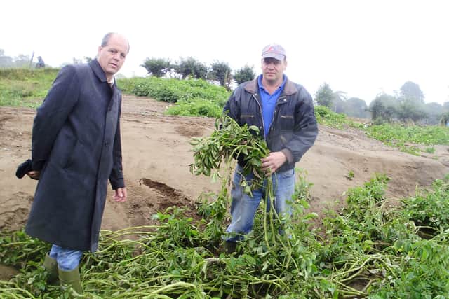 UFU president Graham Furey pictured in August 2008 with Co Down potato grower Robert Magowan. Mr Magowan’s potato crop was washed away in flash flooding