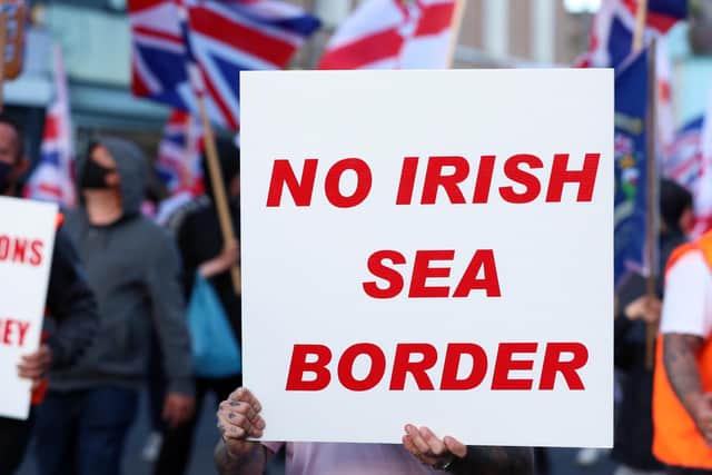 A protester holds a placard opposing the Irish Sea border