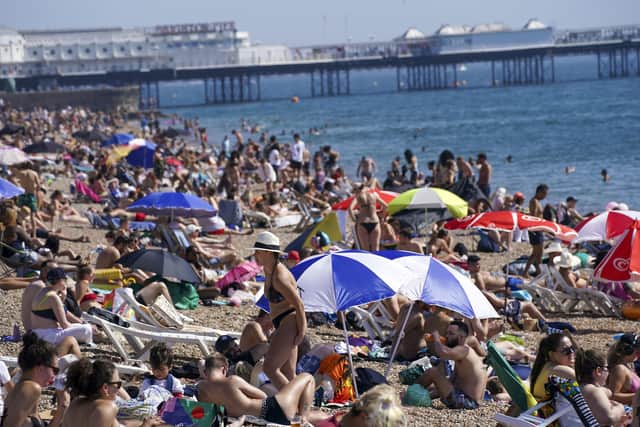 People enjoy the warm weather at Brighton beach in West Sussex on Monday. Temperatures were approaching 30C in parts ofEngland. Photo: Steve Parsons/PA Wire