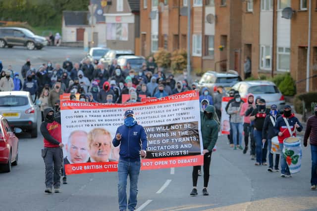 A masked loyalist band make their way through Markethill during a protest event against the Irish Sea Customs Border, and 'two-tier policing'.

Picture: Philip Magowan / PressEye