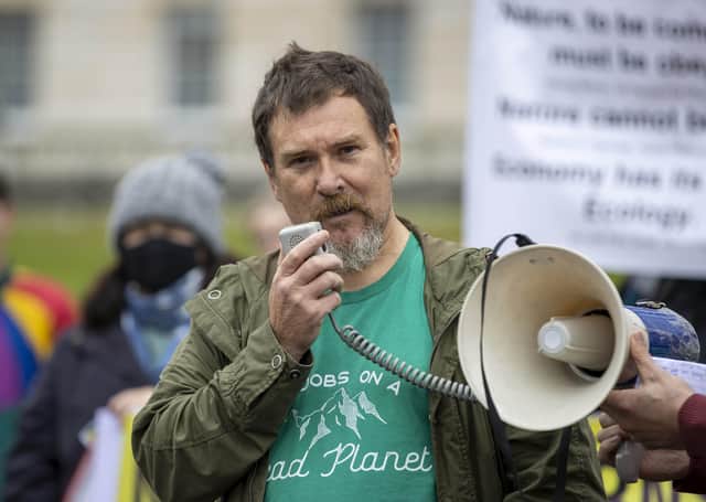 Professor John Barry of Queen's University Belfast (left) speaking during a demonstration with climate activists at the steps of Parliament Buildings, Belfast, calling for a Net-Zero Climate Act to stop the climate crisis. Picture date: Monday September 13 2021.