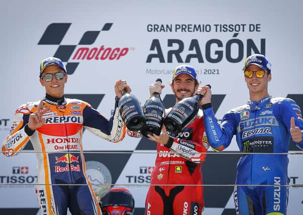 Pecco Bagnaia celebrates winning the Aragon Grand Prix with Marc Marquez and Joan Mir.