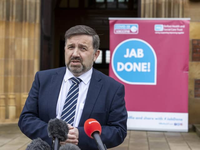 Northern Ireland Minister of Health Robin Swann speaks to media outside Queen's University Belfast's Lanyon Building during a campus vaccine initiative at the university
