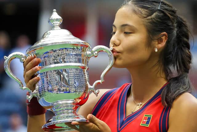 Emma Raducanu celebrates with the US Open championship trophy
