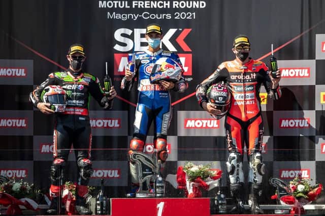 Toprak Razgatlioglu on the podium at Magny-Cours in France with Jonathan Rea (left) and Scott Redding.