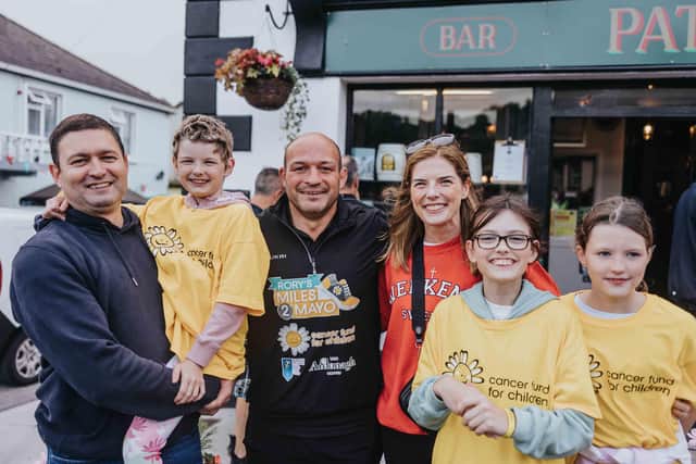 Rory Best arrives into Cong, Co. Mayo having successfully completed his 180 mile walk from Newcastle Co. Down. He is accompanied by Penny O'Brien (6), her parents Kevin and Sinead and sisters Emma and Abigail who have benefited from Cancer Fund for Children support.