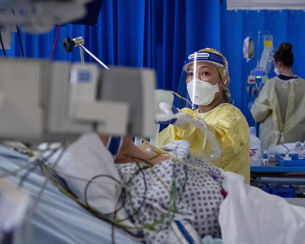 A nurse cares for a Covid patient in an ICU (Intensive Care Unit).