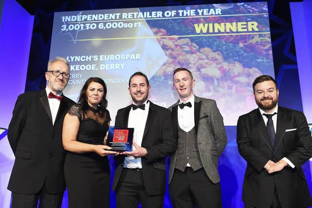 The team from Lynch's Eurospar in Londonderry pick up the Independent Retailer of the Year award at the Retail Industry Awards. Also pictured is David Shrimpton, Editor of Independent Retail News and host, Alex Brooker