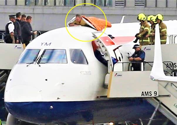 Handout file photo dated 10/10/19 of Extinction Rebellion activist James Brown (CIRCLED), 56, on top of a plane on the morning of October 10 2019 during a protest against flying at London City Airport. The former Paralympic, who has been registered blind since birth, has been jailed for a year at Southwark Crown Court, south london, for supergluing himself to the roof of a British Airways plane during an Extinction Rebellion protest. Issue date: Friday September 24, 2021.