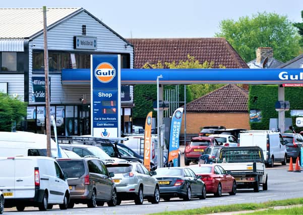 People queue for fuel at a petrol station in Barton, Cambridgeshire yesterday