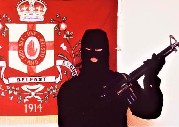 An image of a UVF man with an Armalite assault rifle; the government plans to give an amnesty to all perpetrators of Troubles crimes