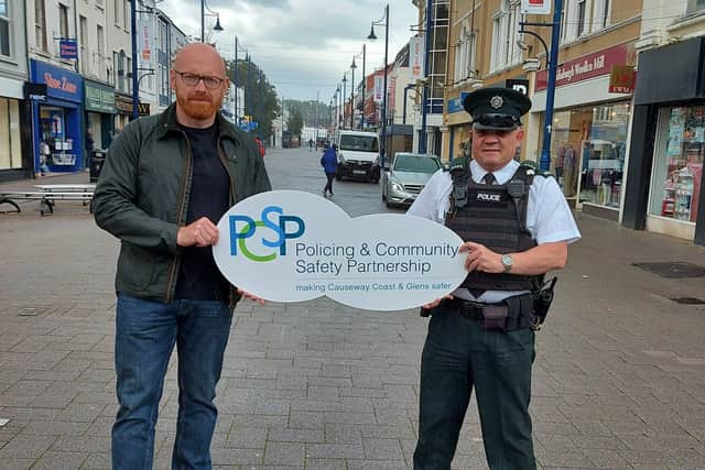 The Chairperson of Causeway Coast and Glens Policing and Community Safety Partnership Councillor Darryl Wilson pictured in Coleraine town centre with Constable Peter Olphert. The PSCP and PSNI are urging the public to be on their guard against High Street Voucher scammers