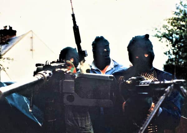 IRA men with two machine guns, one mounted on the back of a lorry, and an assault rifle, south Armagh, 1989