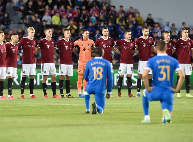 Sparta Prague's players stand while Rangers' midfielder Glen Kamara (front L) and Rangers' defender Borna Barisic take the knee prior to the start of the UEFA Europa League Group A match last week