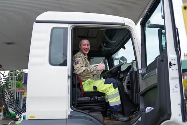 A member of the armed forces sits in the cab of a tanker after helping to deliver fuel to a garage in Essex on Tuesday. Tim McGarry writes: 'Nothing says success like having to bring in the army to ensure fuel supply'