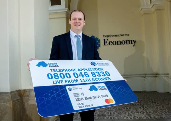Economy Minister Gordon Lyons advertises the telephone number for applications to the High Street vouchers scheme