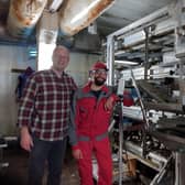 Alan Edwards and the engineer Kasimerias who looks after the machines, recently installed in the Baltic Champs farm in Lithuania