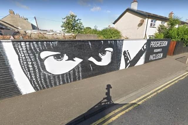 A UVF mural bearing a near-identical image of a man in a balaclava, Davys Street, Carrickfergus