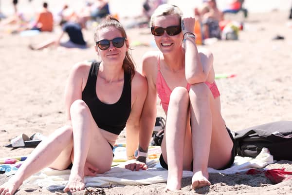 Kerry Rollins and Maria Cassidy at Newcastle beach, Co Down on Thursday as temperatures rose to 28C. 
Photo: Kelvin Boyes / Press Eye.