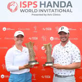 Maja Stark of Sweden and Ewen Ferguson of Scotland pose for a photograph with their trophies after winning the Women’s and Men’s tournaments