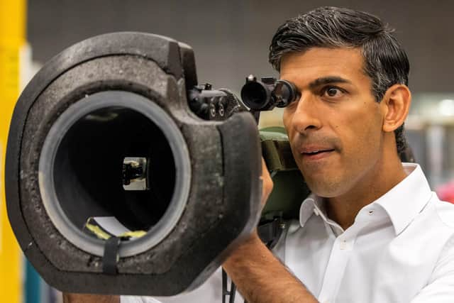 Rishi Sunak looks at a NLAW anti tank launcher, supplied to Ukraine, during a campaign visit to Thales Defence System plant in Belfast yesterday. He says the protocol did not allow him to extend an energy-saving VAT cut to NI