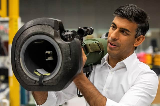 Rishi Sunak looks at a NLAW anti tank launcher, supplied to Ukraine, during a campaign visit to Thales Defence System plant in Belfast