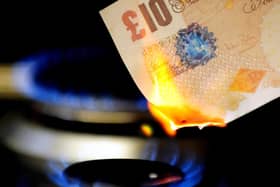 File photo dated 22/04/12 of a £10 note burning on a gas hob. Photo credit: Rui Vieira/PA Wire